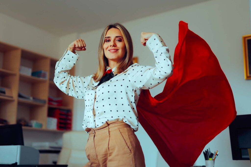 Train the Trainer Program. Strong, professional woman wearing a super hero cape.